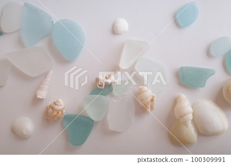Blue sea glass and white shells scattered throughout 100309991