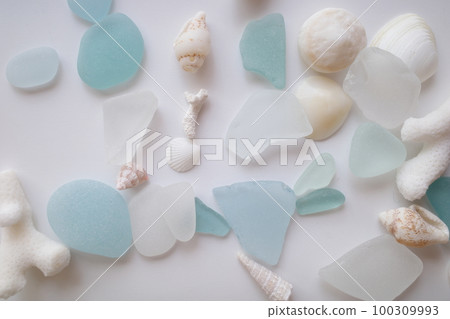 Blue sea glass and white shells scattered throughout 100309993