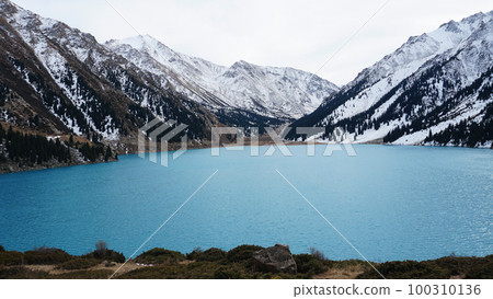 A mountain lake with blue water in winter A mountain lake with blue water in winter 100310136