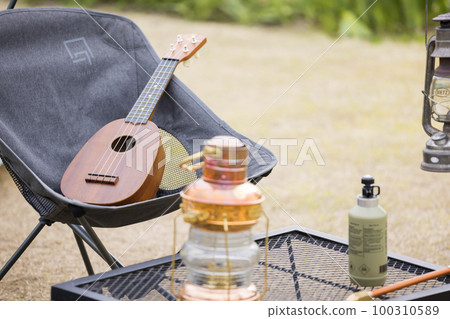 Camp image Ukulele placed on an outdoor chair 100310589