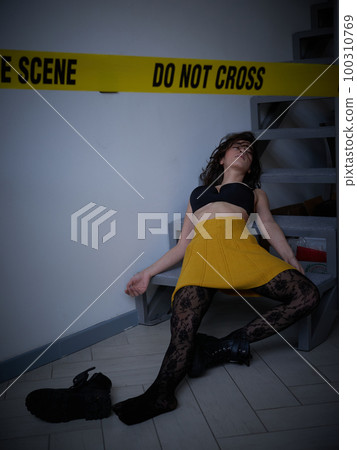 young woman lying dead on the floor after rape 100310769