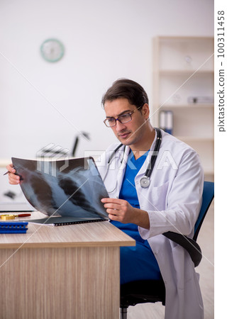 Young male doctor radiologist working in the clinic 100311458