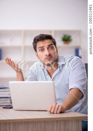 Young male employee working in the office 100311461