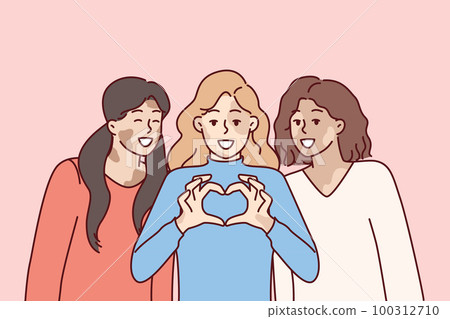 Three women with vitiligo syndrome are smiling demonstrating heart gesture as sign of self-love 100312710