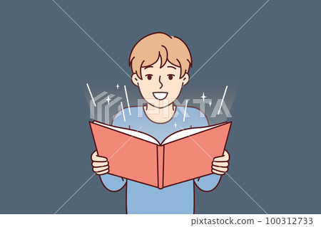 Boy before adolescence with open book in hands reads fairy tale or comics with interest 100312733
