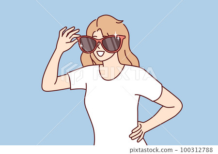 Happy woman with giant sunglasses on face smiles and looks around looking for acquaintances 100312788