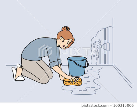 Worried woman clean water from burst pipe Worried woman clean water from burst pipe 100313006