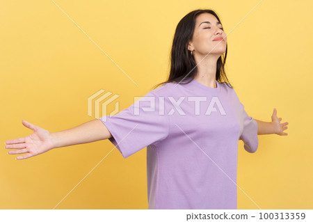 Relaxed woman with her arms open gesturing wellbeing Relaxed woman with her arms open gesturing wellbeing 100313359