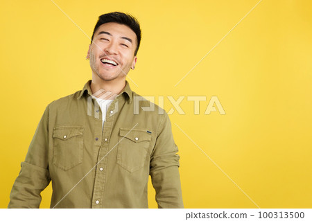 Chinese man laughing and looking at camera Chinese man laughing and looking at camera 100313500