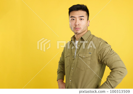 Confident chinese man standing looking at the camera Confident chinese man standing looking at the camera 100313509