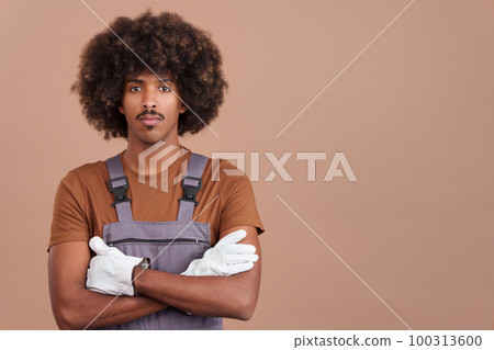 African man carpentry worker looking at camera in work uniform African man carpentry worker looking at camera in work uniform 100313600