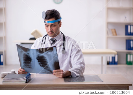 Young male doctor otolaryngologist working in the clinic 100313604