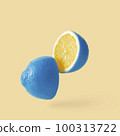 Lemon sureal playful with a blue skin cut into two parts levitation above the background.  100313722