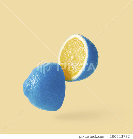 Lemon sureal playful with a blue skin cut into two parts levitation above the background.  Lemon sureal playful with a blue skin cut into two parts levitation above the background.  100313722