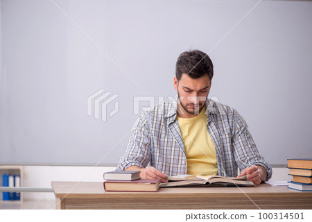 Young male student in front of whiteboard 100314501