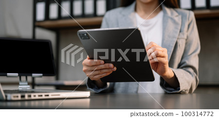 businesswoman hand using smart phone, tablet payments and holding credit card online shopping, omni channel, digital tablet docking keyboard computer at office . businesswoman hand using smart phone, tablet payments and holding credit card online shopping, omni channel, digital tablet docking keyboard computer at office . 100314772
