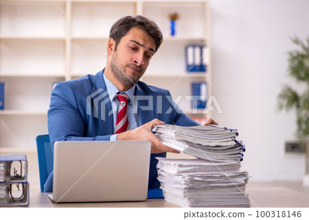 Young male employee working in the office 100318146