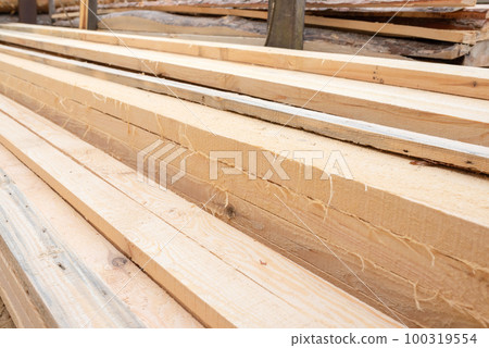 Sawmill. Pile of pine planks in a sawmill warehouse. Timber industry Sawmill. Pile of pine planks in a sawmill warehouse. Timber industry 100319554