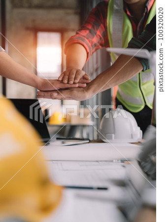 Team architects workers  join hands to join forces to join forces to work for the industry for success. Teamwork and professional colleagues 100320020