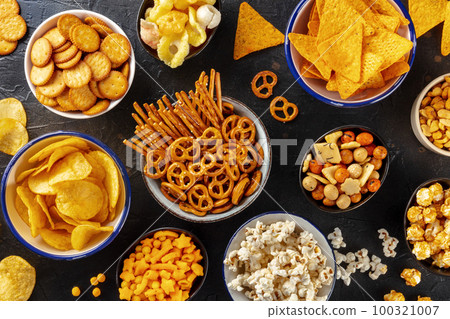 Salty snacks, party mix. An assortment of crispy appetizers, overhead 100321007
