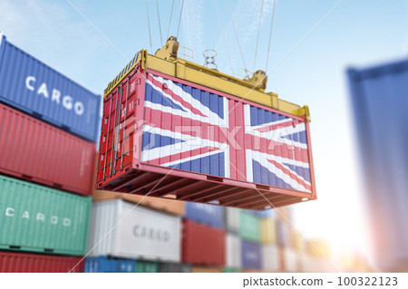 Cargo shipping container with UK United Kingdom flag in a port harbor. Production, delivery, shipping and freight transportation of UK products concept. 100322123