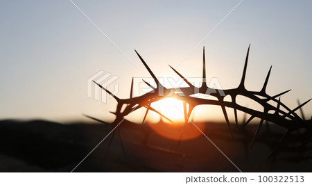The cross and crown of thorns symbolizing the sacrifice and suffering of Jesus Christ and the red sunset, Passion Week and Lent concept The cross and crown of thorns symbolizing the sacrifice and suffering of Jesus Christ and the red sunset, Passion Week and Lent concept 100322513