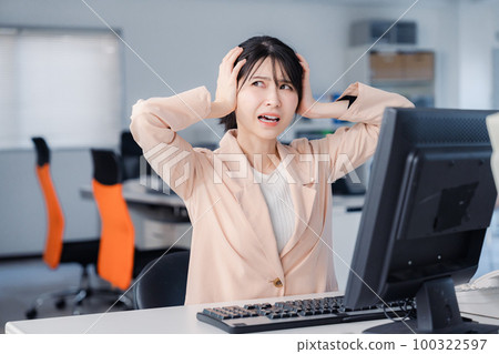 Tired businesswoman working overtime until morning Tired businesswoman working overtime until morning 100322597
