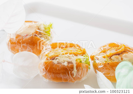 Croquette bread wrapped in plastic wrap on white background Croquette bread wrapped in plastic wrap on white background 100323121