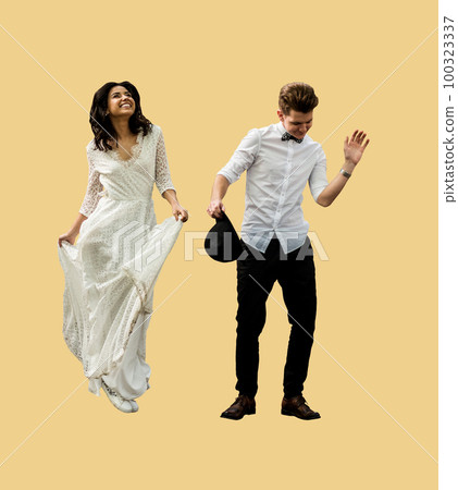 Merry happy young couple newlyweds have fun dancing on a isolated background Merry happy young couple newlyweds have fun dancing on a isolated background 100323337