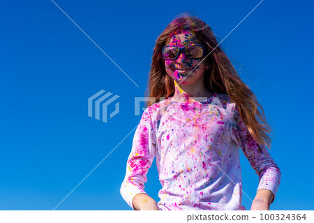 Young european girl celebrating holy festival on a blue sky background 100324364