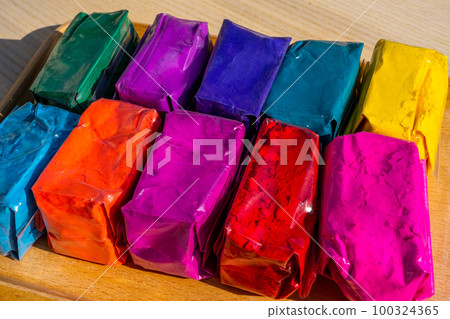 Dry colours Gulal packed in plastic pack placed at market shop for sale for Indian Festival Holi 100324365