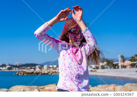 Young european girl celebrating holy festival on a blue sky background 100324367