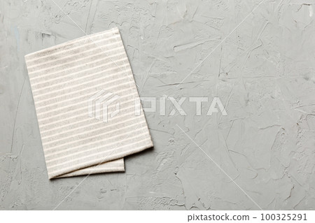 top view with gray kitchen napkin isolated on table background. Folded cloth for mockup with copy space, Flat lay. Minimal style top view with gray kitchen napkin isolated on table background. Folded cloth for mockup with copy space, Flat lay. Minimal style 100325291