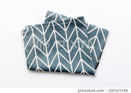 top view with blue kitchen napkin isolated on table background. Folded cloth for mockup with copy space, Flat lay. Minimal style top view with blue kitchen napkin isolated on table background. Folded cloth for mockup with copy space, Flat lay. Minimal style 100325346