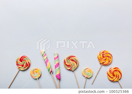 Set of colorful lollipops on colored background. Summer concept. Party Happy Birthday or Minimalist Concept Set of colorful lollipops on colored background. Summer concept. Party Happy Birthday or Minimalist Concept 100325366