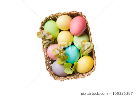 Basket of colorful Easter eggs isolated on white background. Easter basket filled with colored eggs top view holiday concept Basket of colorful Easter eggs isolated on white background. Easter basket filled with colored eggs top view holiday concept 100325397