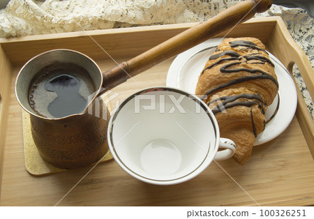 morning Breakfast in bed a Cup of coffee with croissant on wooden tray 100326251