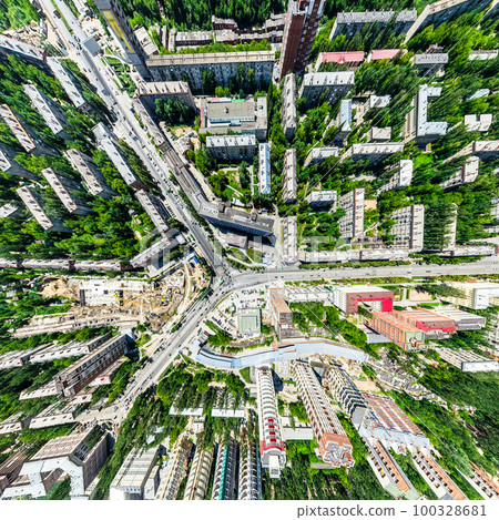 Aerial city view with crossroads and roads, houses, buildings, parks and parking lots. Sunny summer panoramic image 100328681