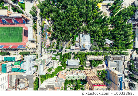 Aerial city view with crossroads and roads, houses, buildings, parks and parking lots. Sunny summer panoramic image Aerial city view with crossroads and roads, houses, buildings, parks and parking lots. Sunny summer panoramic image 100328683