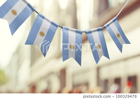 A garland of Argentina national flags on an abstract blurred background 100329478