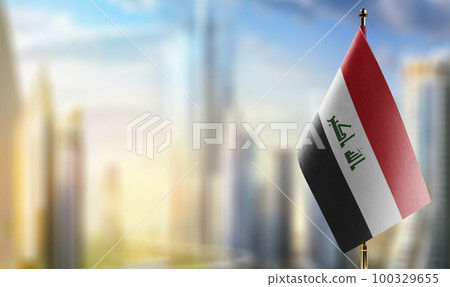 Small flags of the Iraq on an abstract blurry background 100329655