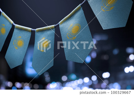 A garland of Kazakhstan national flags on an abstract blurred background 100329667