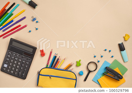 Flat lay photo of workspace desk with school accessories or office supplies on pink background. Flat lay photo of workspace desk with school accessories or office supplies on pink background. 100329796