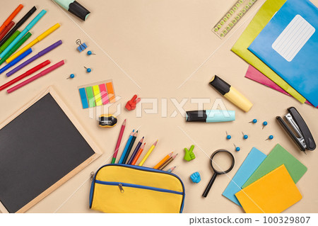 Flat lay photo of workspace desk with school accessories or office supplies on pink background. Flat lay photo of workspace desk with school accessories or office supplies on pink background. 100329807
