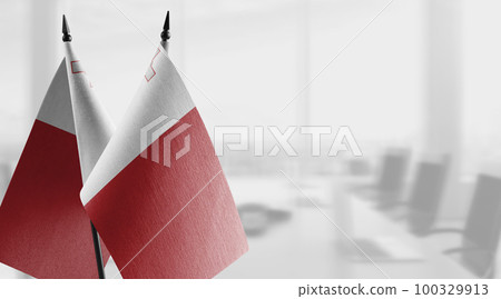 Small flags of the Malta on an abstract blurry background Small flags of the Malta on an abstract blurry background 100329913