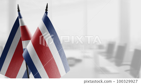 Small flags of the Costa Rica on an abstract blurry background Small flags of the Costa Rica on an abstract blurry background 100329927