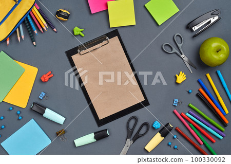 Flat lay photo of workspace desk with school accessories or office supplies on gray background. Flat lay photo of workspace desk with school accessories or office supplies on gray background. 100330092