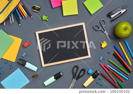 Flat lay photo of workspace desk with school accessories or office supplies on gray background. Flat lay photo of workspace desk with school accessories or office supplies on gray background. 100330102