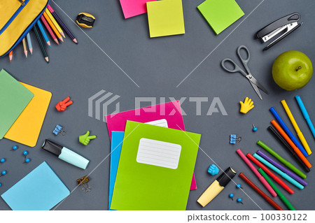 Flat lay photo of workspace desk with school accessories or office supplies on gray background. 100330122