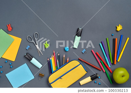 Flat lay photo of workspace desk with school accessories or office supplies on gray background. Flat lay photo of workspace desk with school accessories or office supplies on gray background. 100330213